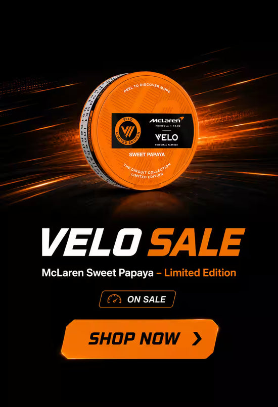 Orange tennis ball with McLaren branding on a black background, featuring 'VELO SALE' text.